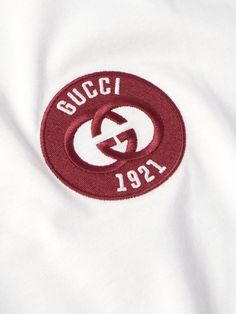 Gucci's ringer-style T-shirt is embroidered with its 'GG' emblem and founding year, 1921, at the chest. It's been made in Italy from smooth, lightweight cotton-jersey and cut for a relaxed fit. Wear yours under one of the label's blazers or cardigans. Gucci Designer T-shirt With Letter Print, Gucci Short Sleeve T-shirt With Logo Print, White Gucci T-shirt With Logo Print, Luxury Gucci T-shirt, Gucci White Graphic Print T-shirt, Tom Ford Bag, Gucci Outfits, Wardrobe Edit, Classic Sneakers