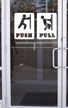 the door is open and there are two signs on it that say push pull down