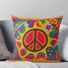 a peace sign pillow on a couch