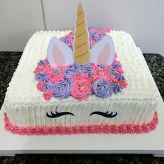 a cake decorated with flowers and an unicorn's horn