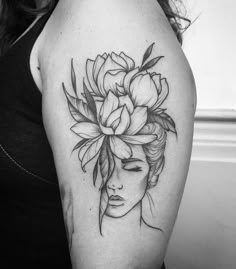 a woman's head with flowers in her hair on the left upper half of her arm