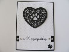 a card with a black heart and paw prints