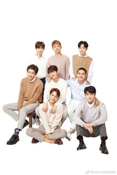 the group of young men are posing together for a photo in front of a white background