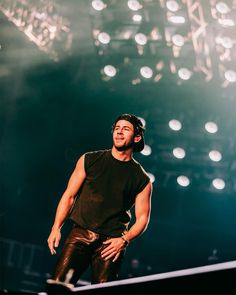 a male in a black shirt and some lights