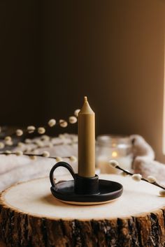 a lit candle sitting on top of a wooden table