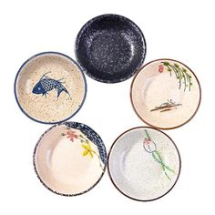 four plates with birds painted on them are arranged in a circle