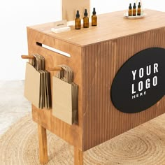 a wooden box with some bottles on it and a sign that says your logo here