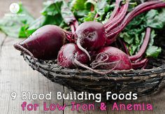 a basket filled with beets sitting on top of a wooden table next to greens