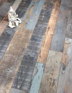 an old wooden floor with peeling paint and wood planks on the bottom part of it