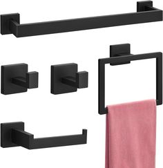 black bathroom accessories with pink towels hanging on the wall and in front of it is a towel rack