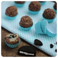 chocolate cupcakes and oreo cookies on a blue polka dot tablecloth next to each other