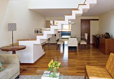 a living room filled with furniture and a stair case