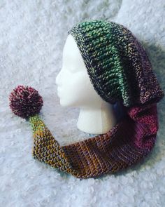 a knitted hat and scarf with a pom - pom attached to it