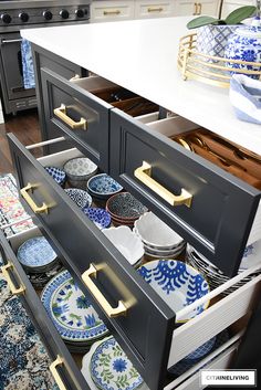 an open drawer in a kitchen filled with plates