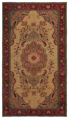 an antique persian rug with red and green accents