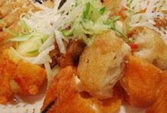 some food is laying out on a plate with grated parmesan cheese and lettuce