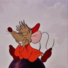 a cartoon mouse sitting on top of a ball