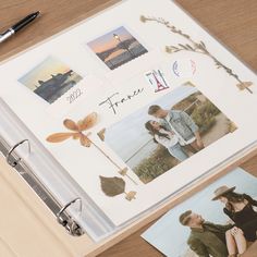 an open album with photos and pens on it