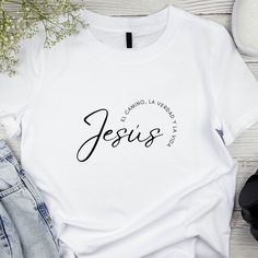 "Jesús: El Camino, La Verdad, y La Vida." This design is crafted to spread a message of faith and inspiration.Our t-shirt is available in a variety of sizes and colors, ensuring you can find the perfect fit and style to suit your taste. Whether you want to wear your faith proudly or give a thoughtful gift to someone special, our new design t-shirt is an excellent choice. Embrace and share this powerful message with style! T Shirt Jesus Christ, Faith Based T Shirts, Jesus Shirts Christ Follower Life, Catholic Tshirts, Cotton T-shirt With Faith Text Print, Faith Clothing, Design T Shirt, News Design, Shirt Ideas