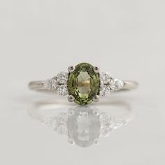 an oval green and white diamond ring