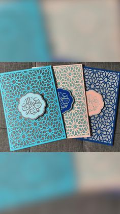 three different colored cards with arabic writing on them