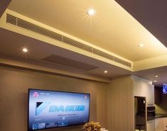 a large flat screen tv mounted to the side of a wall in a living room