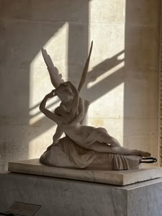 a statue is shown in the middle of a room with sunlight streaming through it and casting shadows on the wall