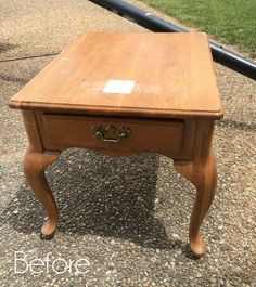 a small wooden table sitting on top of gravel