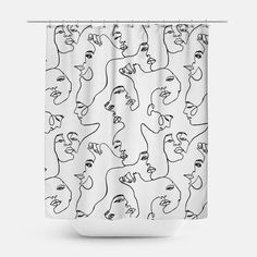 a white shower curtain with black and white faces on the front, in an abstract manner