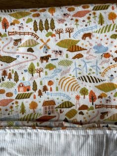 a close up of a baby's diaper with trees and houses on it