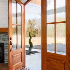 an open door leading to a living room with a fire place