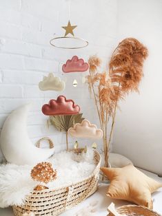 a basket with clouds and stars hanging from the ceiling next to other items on display