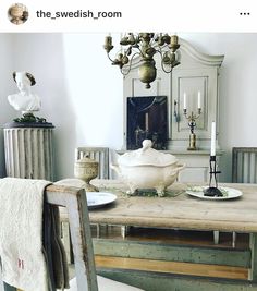 a dining room table with dishes and candles on it