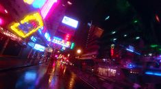 a city street at night with neon lights