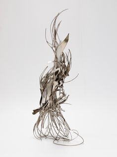 a sculpture made out of metal wire on a white background