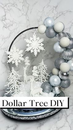 the dollar tree diy is on display in front of a marble background with silver and white ornaments