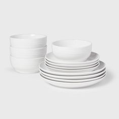 a stack of white dishes sitting on top of each other