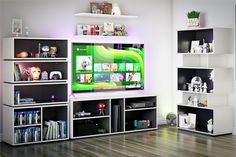 a living room with white shelves filled with books and video game memorabilia on top of them