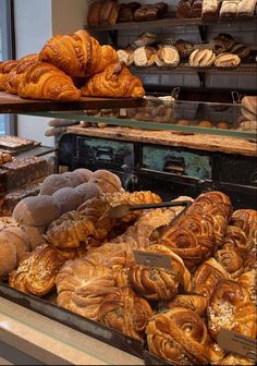 breads and pastries on display in a bakery