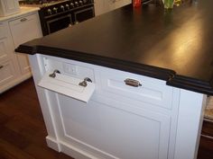 a black counter top in a white kitchen