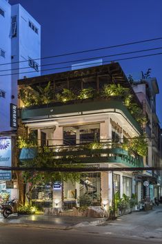 the building has plants growing on it's balconies