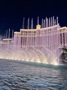 the las vegas hotel and casino is lit up at night with water shooting from its fountains