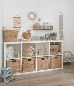 a white shelf filled with baskets and other items