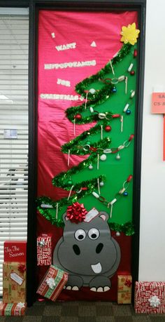 a door decorated with a christmas tree and hippo