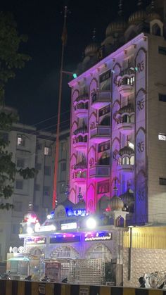 a tall building lit up with purple lights