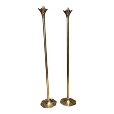 pair of brass candlesticks with leaves on them