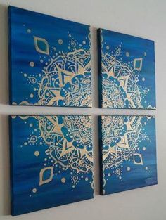 three pieces of blue and gold art hanging on the wall in a room with white walls