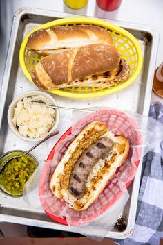 hot dogs and other food items on a tray