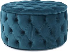 a blue velvet ottoman with buttons on the top and bottom, sitting in front of a white background