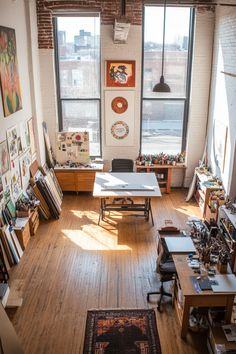 an overhead view of a room with lots of art on the walls and wooden floors